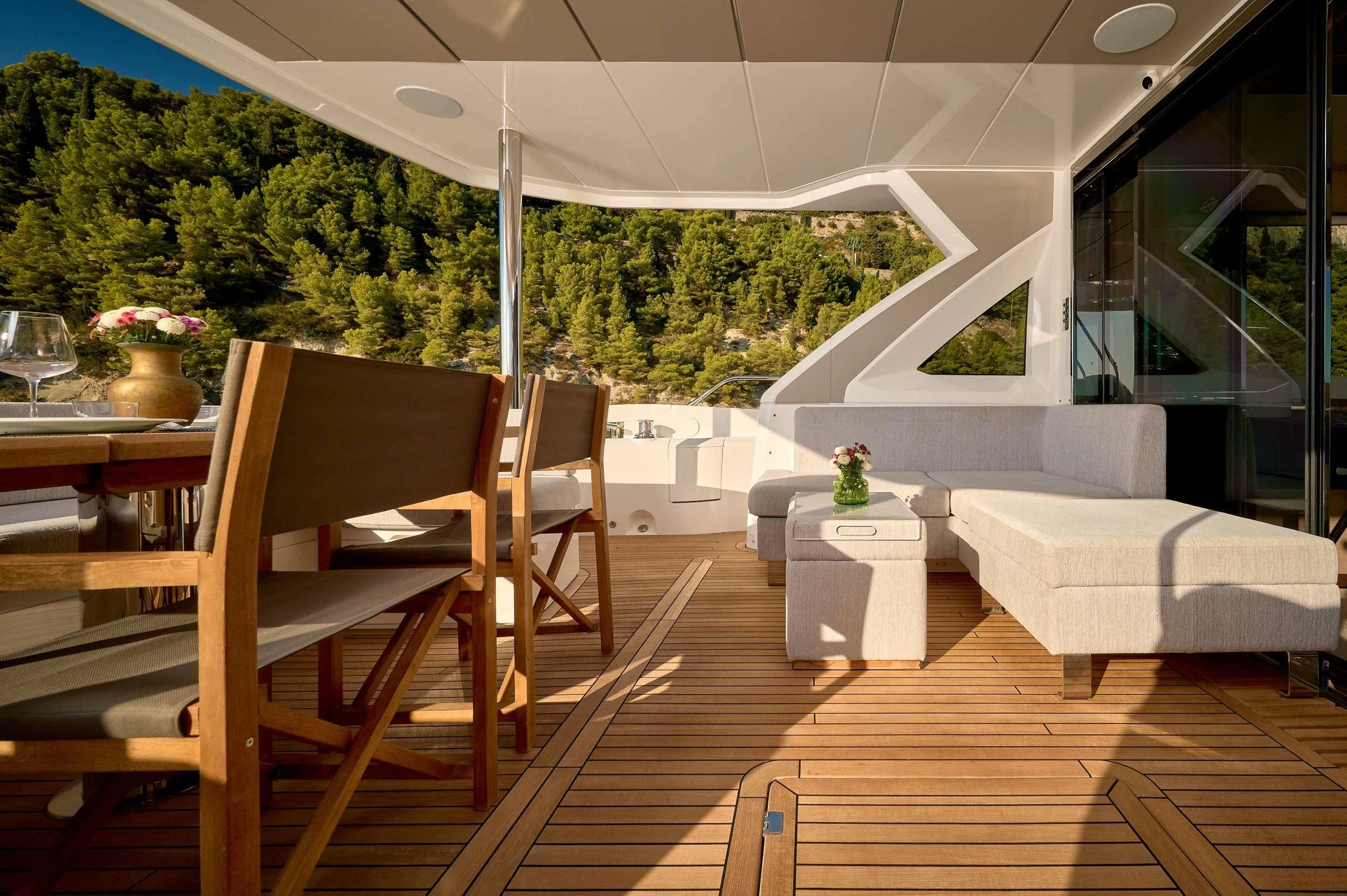 a deck with a table and chairs aboard HIDEAWAY Yacht for Charter