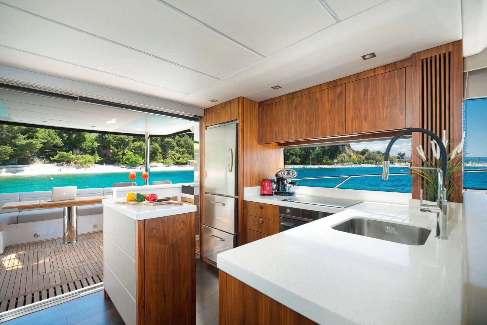 a kitchen with a sink and a large window aboard HIDEAWAY Yacht for Charter