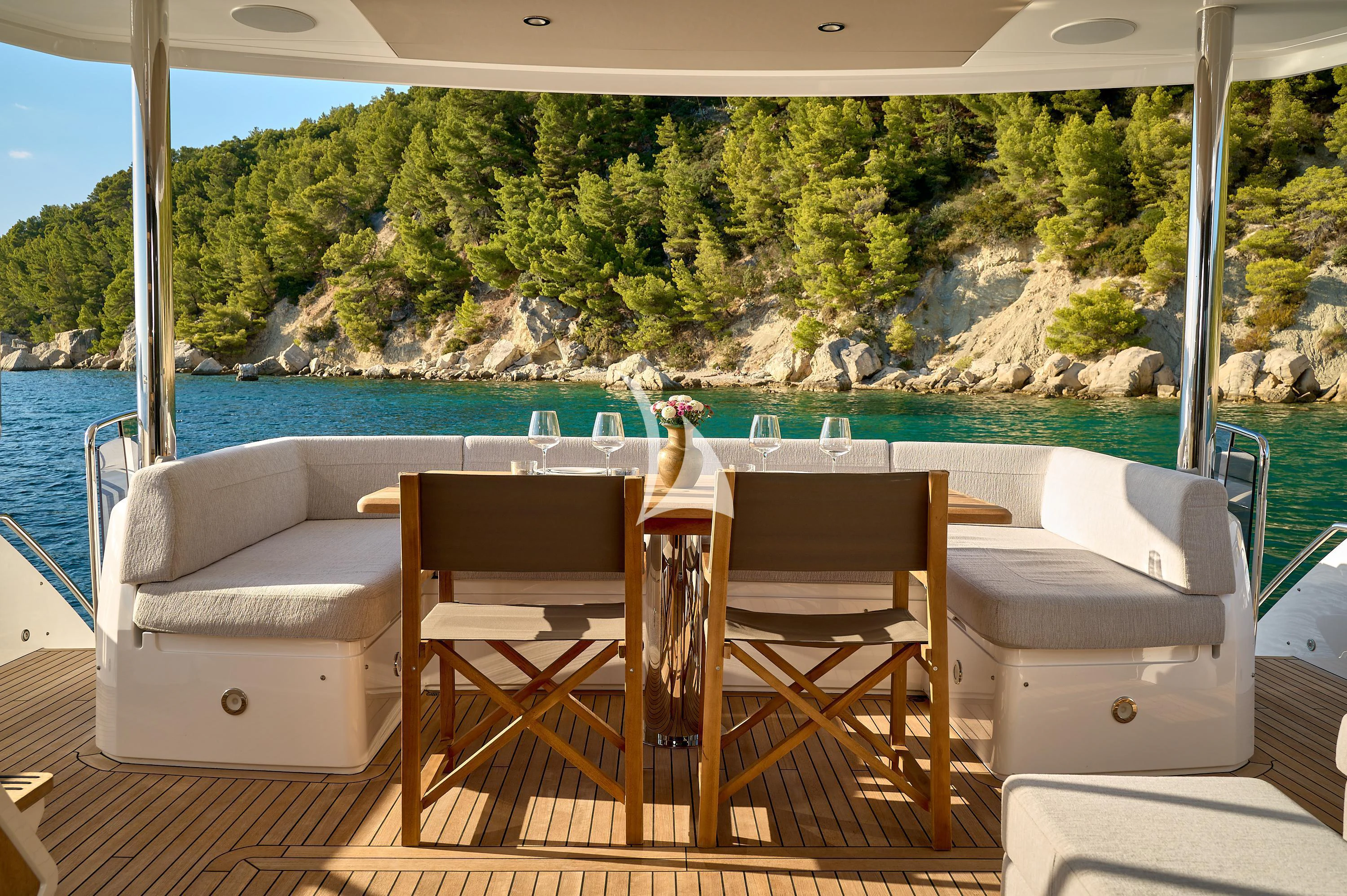 a table and chairs on a deck overlooking a body of water aboard HIDEAWAY Yacht for Charter
