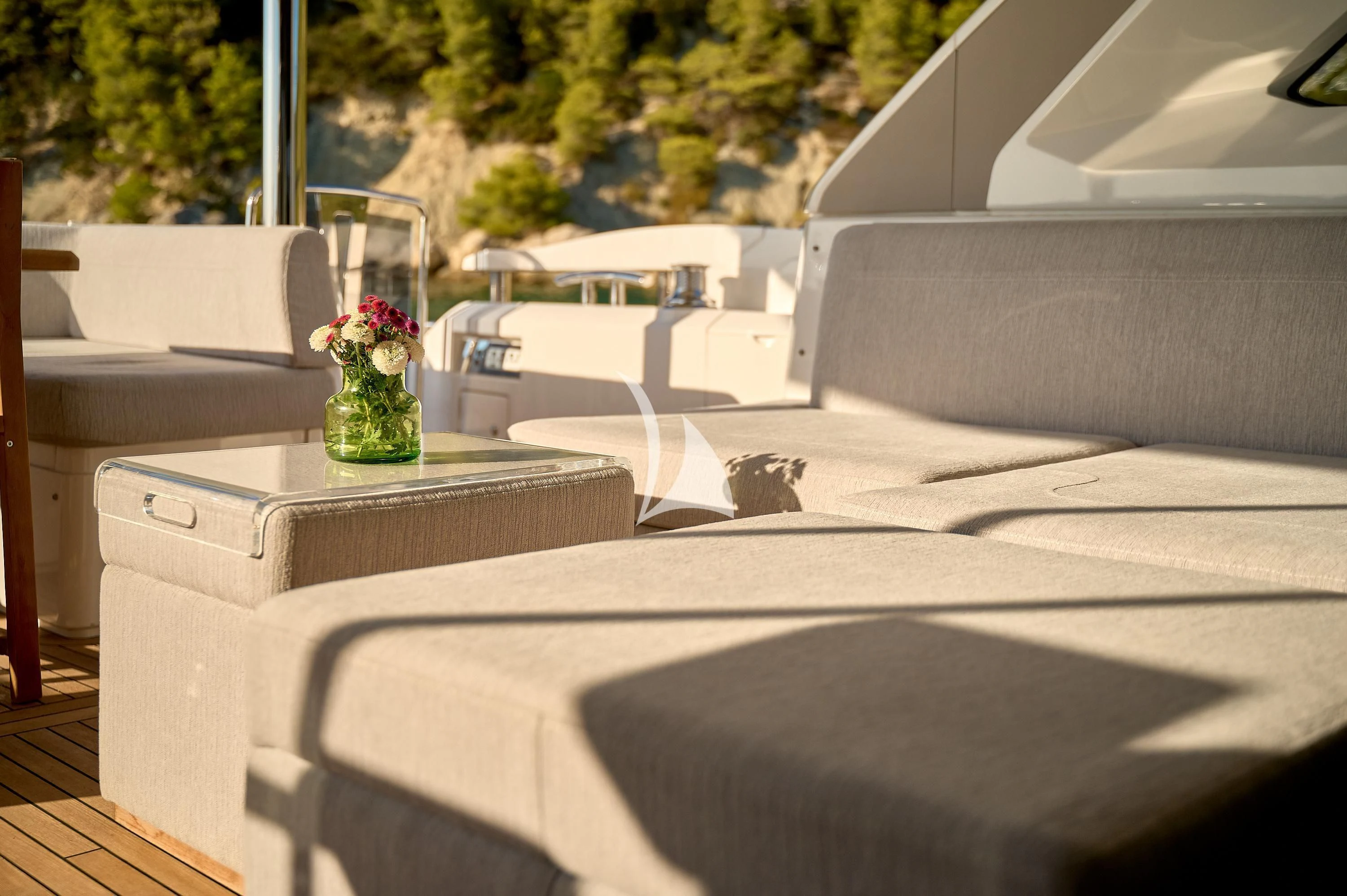 a room with a couch and a vase of flowers on a table aboard HIDEAWAY Yacht for Charter