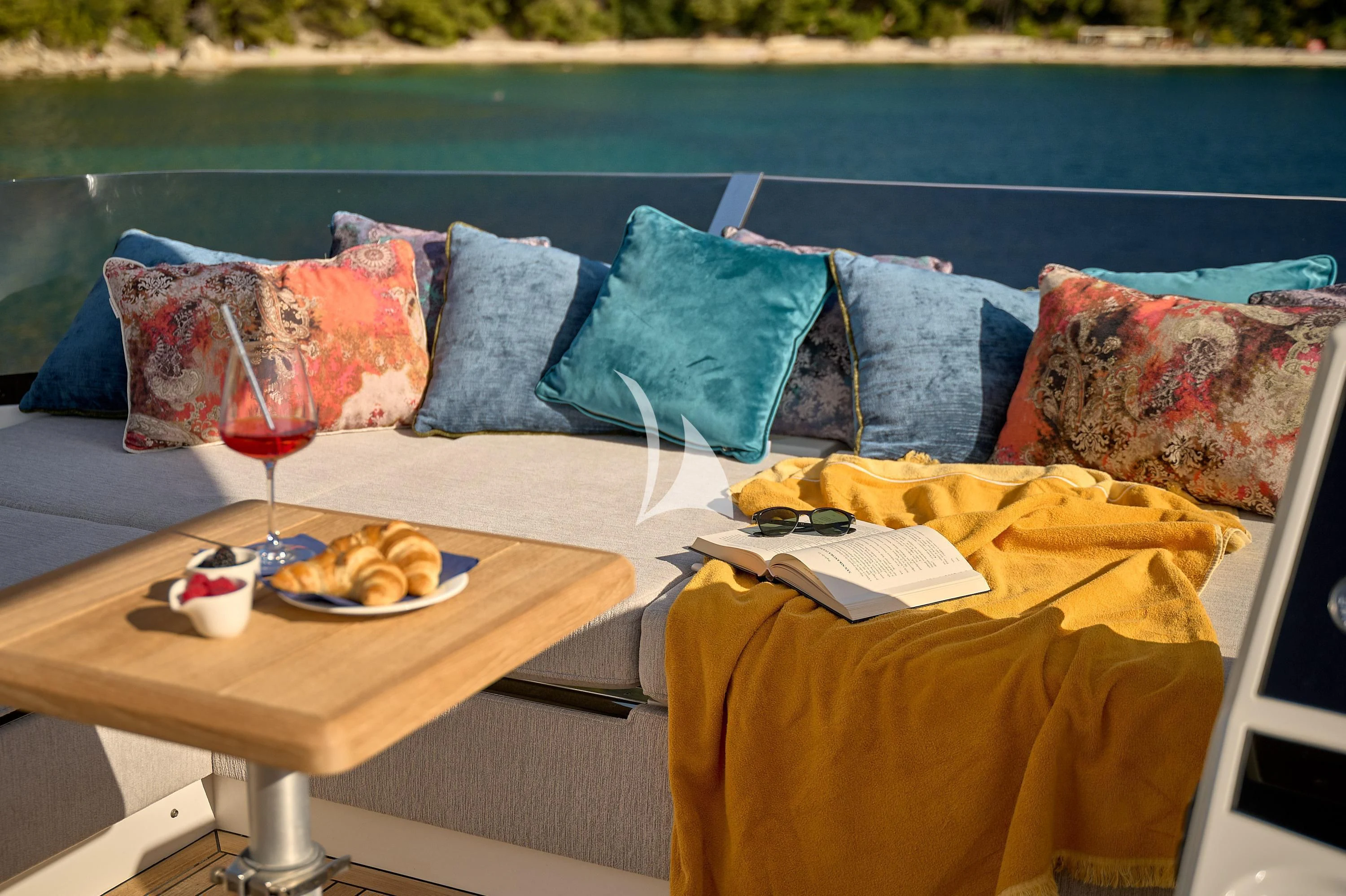 a table with a glass of wine and a tray of food on it aboard HIDEAWAY Yacht for Charter