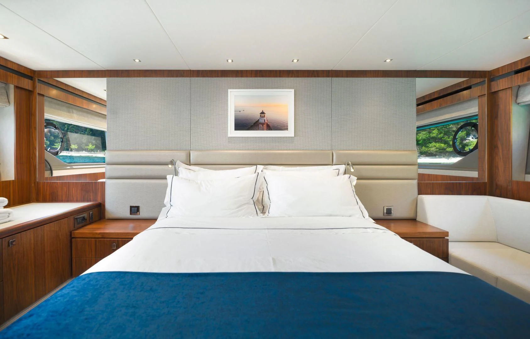 a bed with blue sheets aboard HIDEAWAY Yacht for Charter