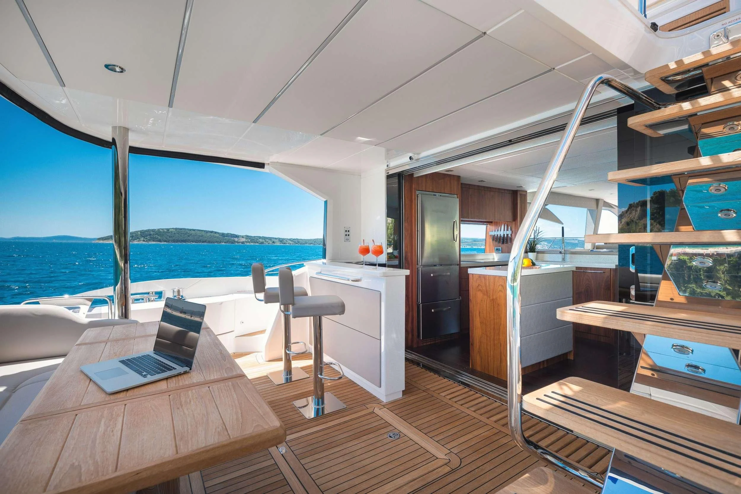 a room with a laptop and a table and chairs aboard HIDEAWAY Yacht for Charter