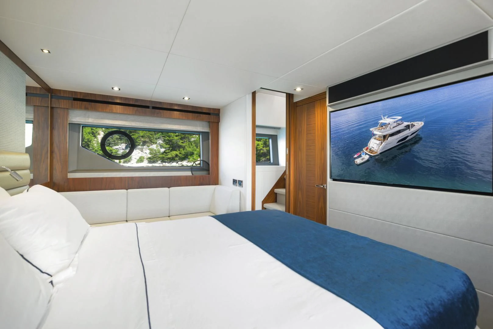 a room with a bed and a television aboard HIDEAWAY Yacht for Charter