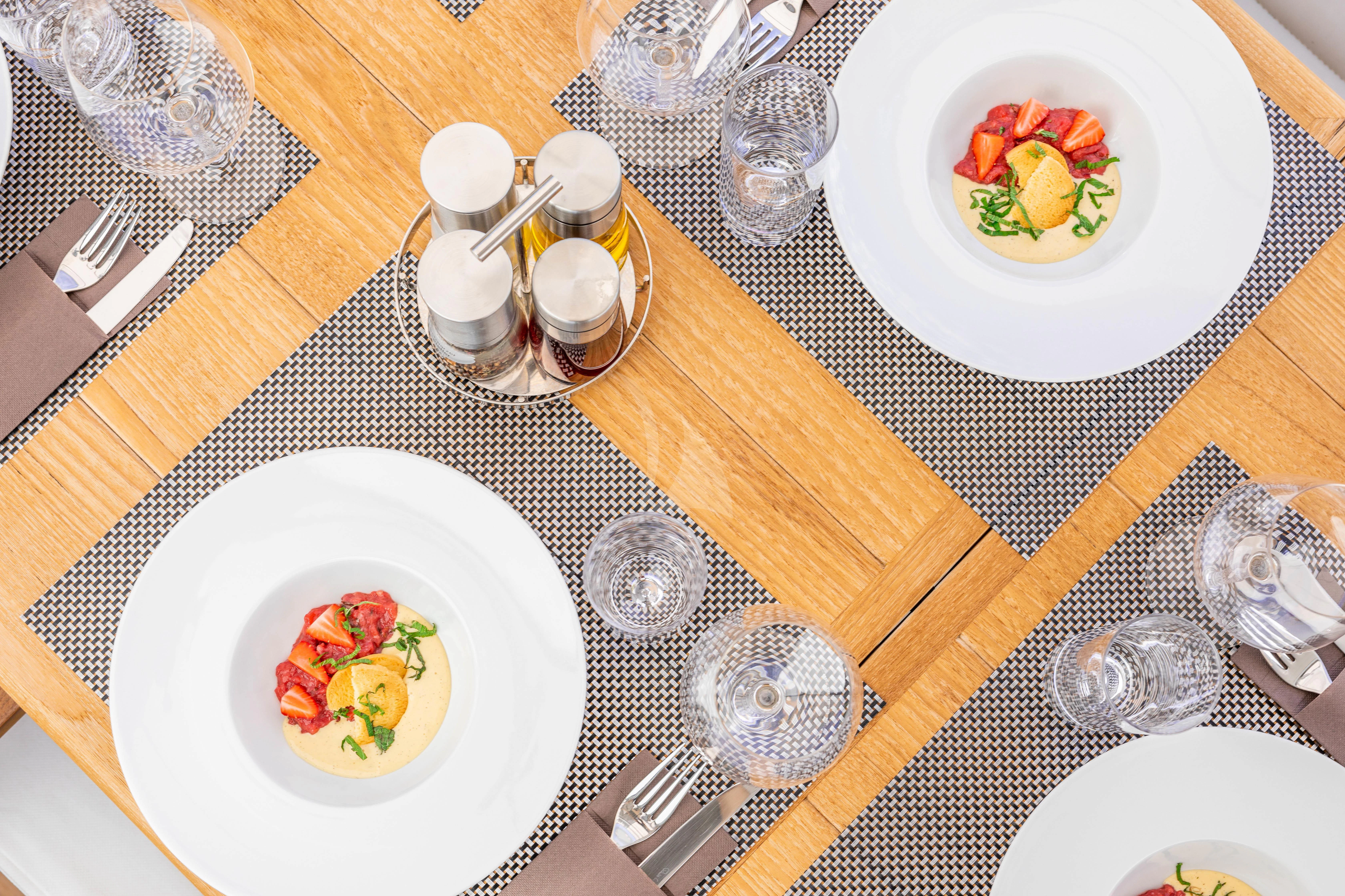 a table with plates and bowls aboard HIDEAWAY Yacht for Charter