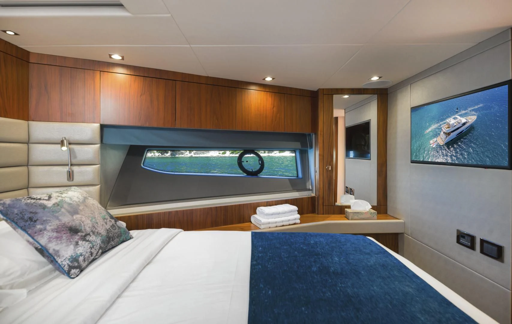 a large hotel room with a large bed and a large television aboard HIDEAWAY Yacht for Charter