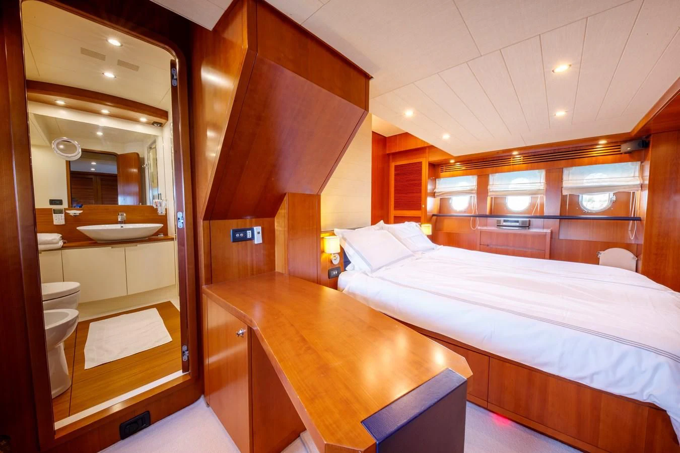 a room with a bed and a table aboard TRUE AUSTRIAN Yacht for Sale