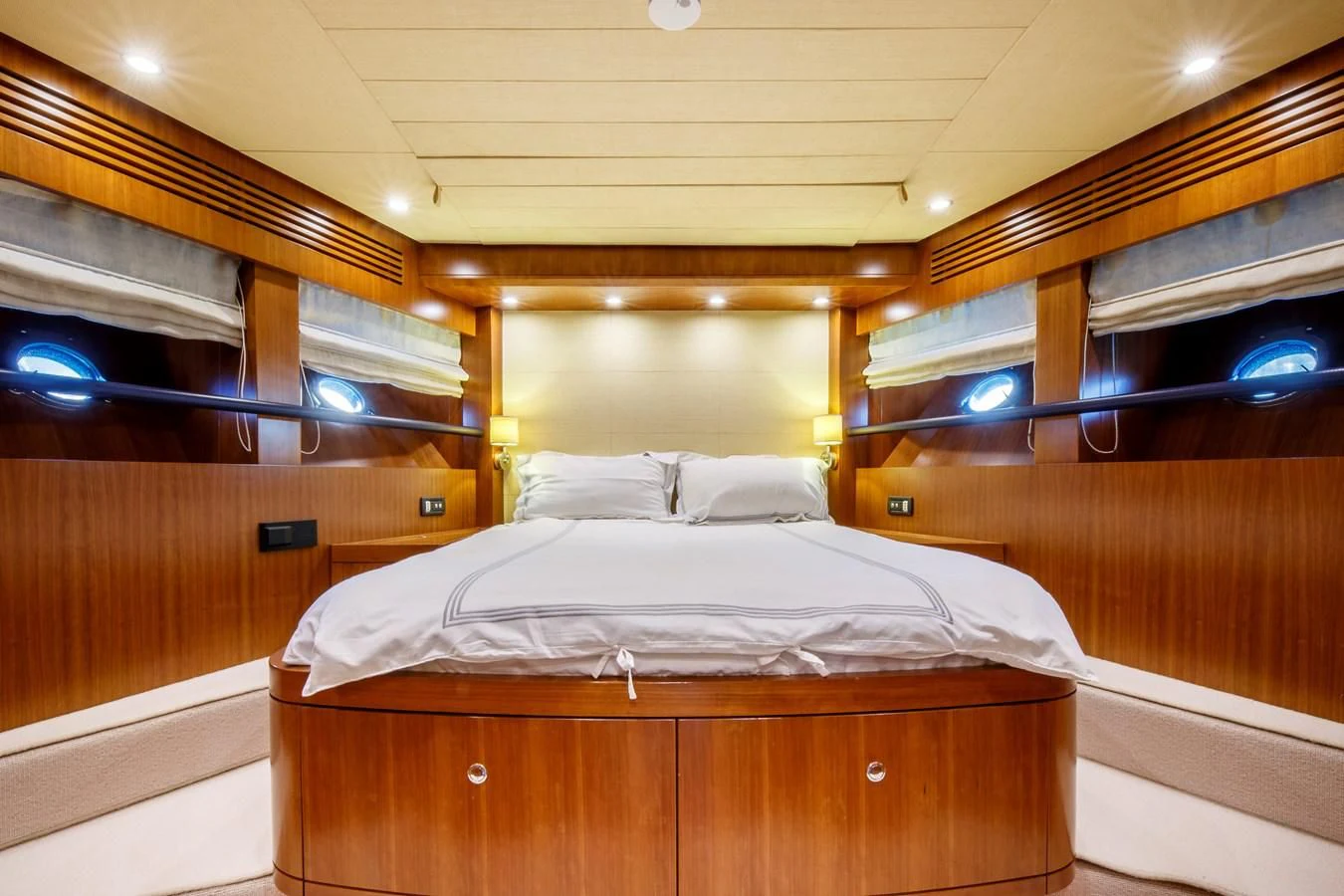 a bed with a wooden headboard aboard TRUE AUSTRIAN Yacht for Sale