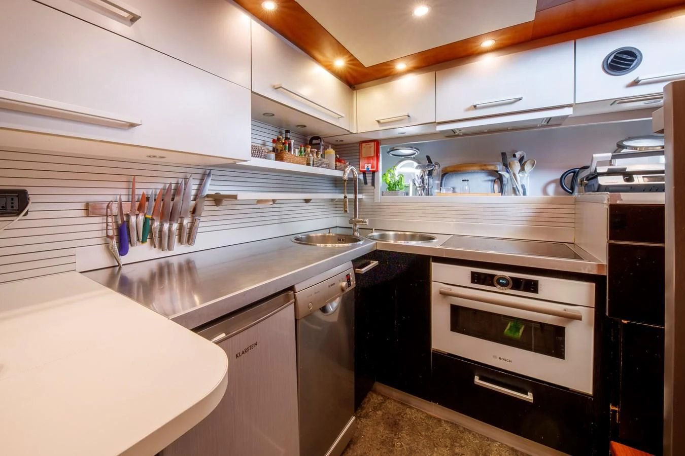 a kitchen with white cabinets aboard TRUE AUSTRIAN Yacht for Sale
