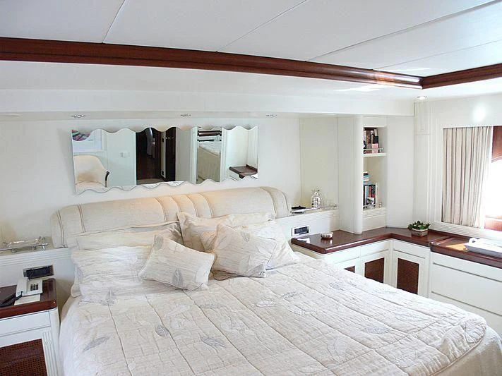 a large white bed with white sheets aboard LADY IN BLUE Yacht for Sale