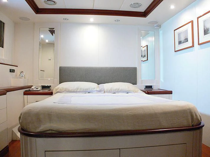 a bed with white sheets aboard LADY IN BLUE Yacht for Sale