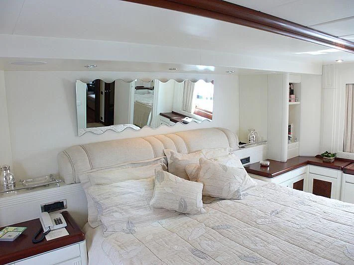 a large bed with white pillows aboard LADY IN BLUE Yacht for Sale