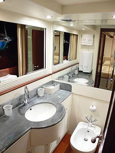 a bathroom with a sink and a mirror aboard LADY IN BLUE Yacht for Sale