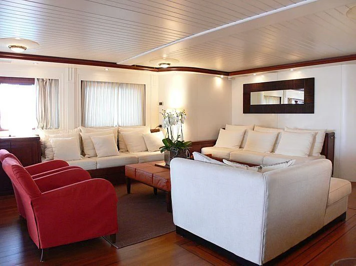 a living room with a couch and a table aboard LADY IN BLUE Yacht for Sale
