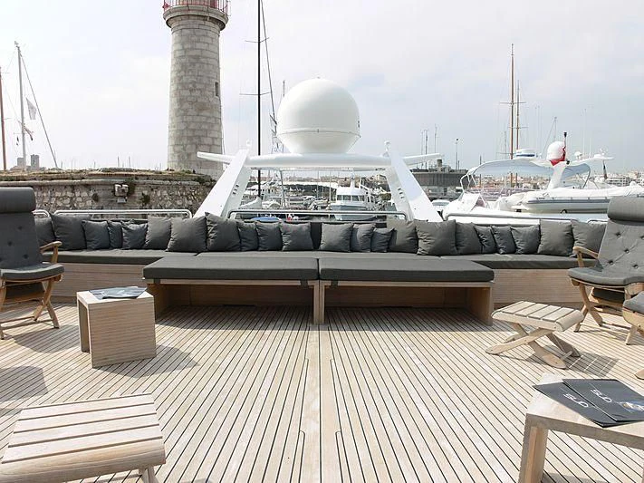 a deck with a large ship in the background aboard LADY IN BLUE Yacht for Sale