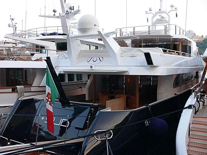 a large white boat with flags aboard LADY IN BLUE Yacht for Sale