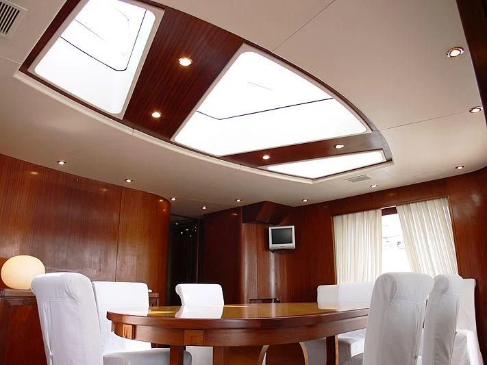 a room with tables and chairs aboard LADY IN BLUE Yacht for Sale