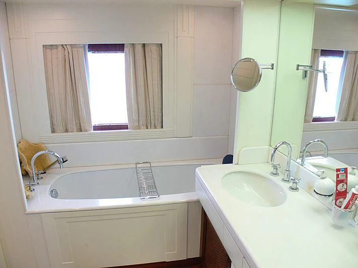 a bathroom with a sink and a mirror aboard LADY IN BLUE Yacht for Sale