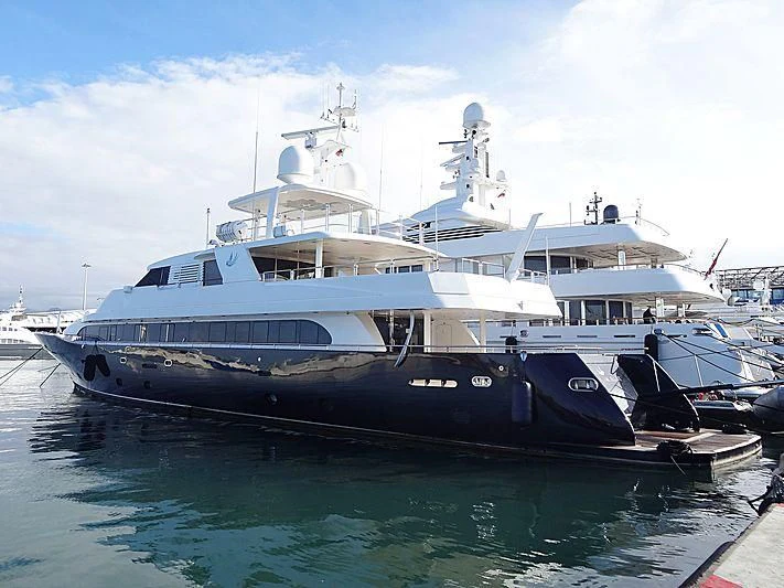 a large white boat in a harbor aboard LADY IN BLUE Yacht for Sale