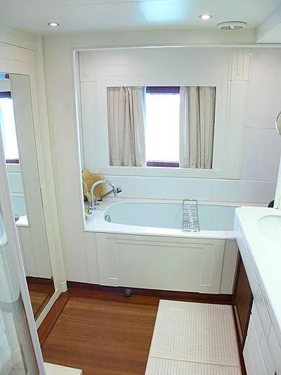 a bathroom with a tub sink and cabinets aboard LADY IN BLUE Yacht for Sale