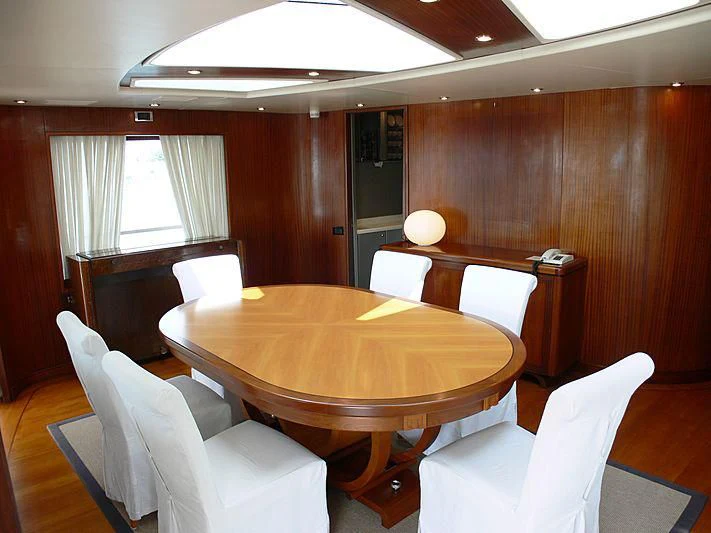 a room with a table and chairs aboard LADY IN BLUE Yacht for Sale