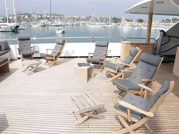 a deck with chairs and tables on it aboard LADY IN BLUE Yacht for Sale
