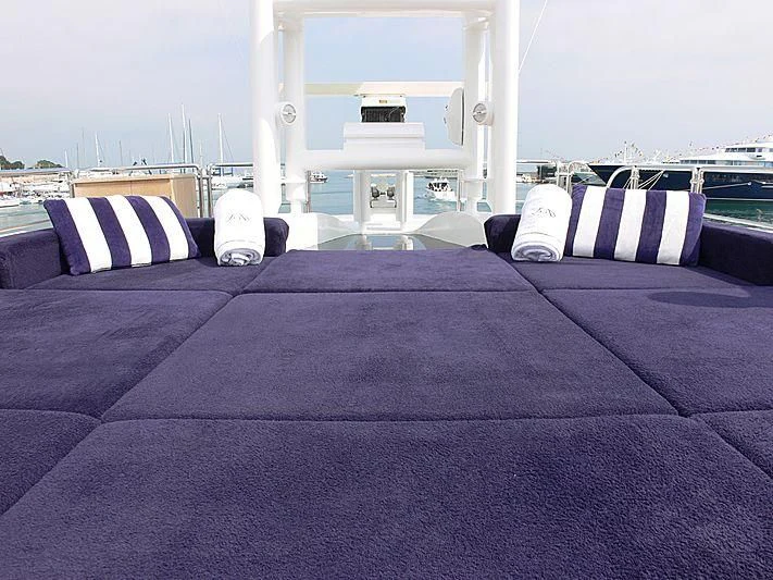 a bed with a purple blanket aboard LADY IN BLUE Yacht for Sale