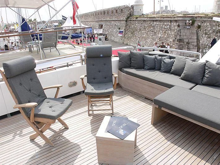 a couch and a table on a deck aboard LADY IN BLUE Yacht for Sale