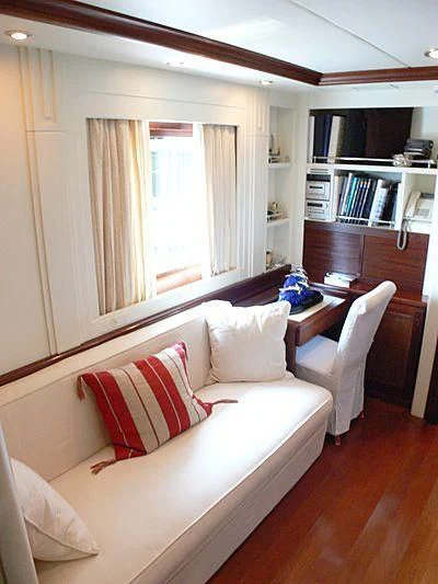 a room with a couch and a bookcase aboard LADY IN BLUE Yacht for Sale
