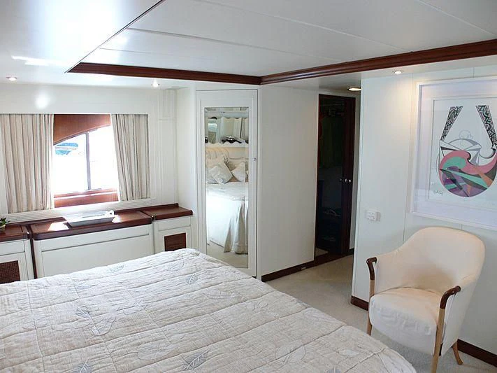 a bedroom with a bed and a desk aboard LADY IN BLUE Yacht for Sale