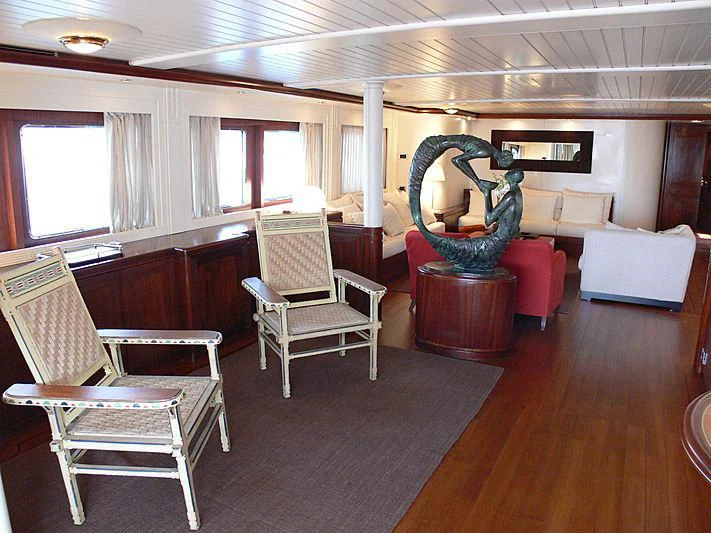 a room with chairs and a fan aboard LADY IN BLUE Yacht for Sale