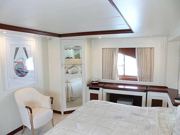 a bedroom with a bed and a desk aboard LADY IN BLUE Yacht for Sale