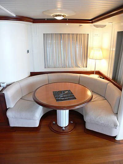 a living room with a couch and a coffee table aboard LADY IN BLUE Yacht for Sale