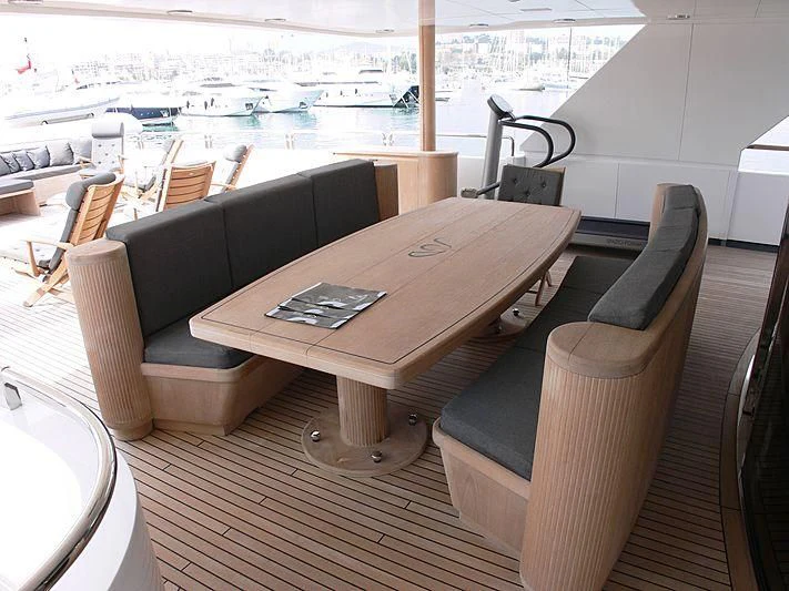 a table with chairs and a bench aboard LADY IN BLUE Yacht for Sale