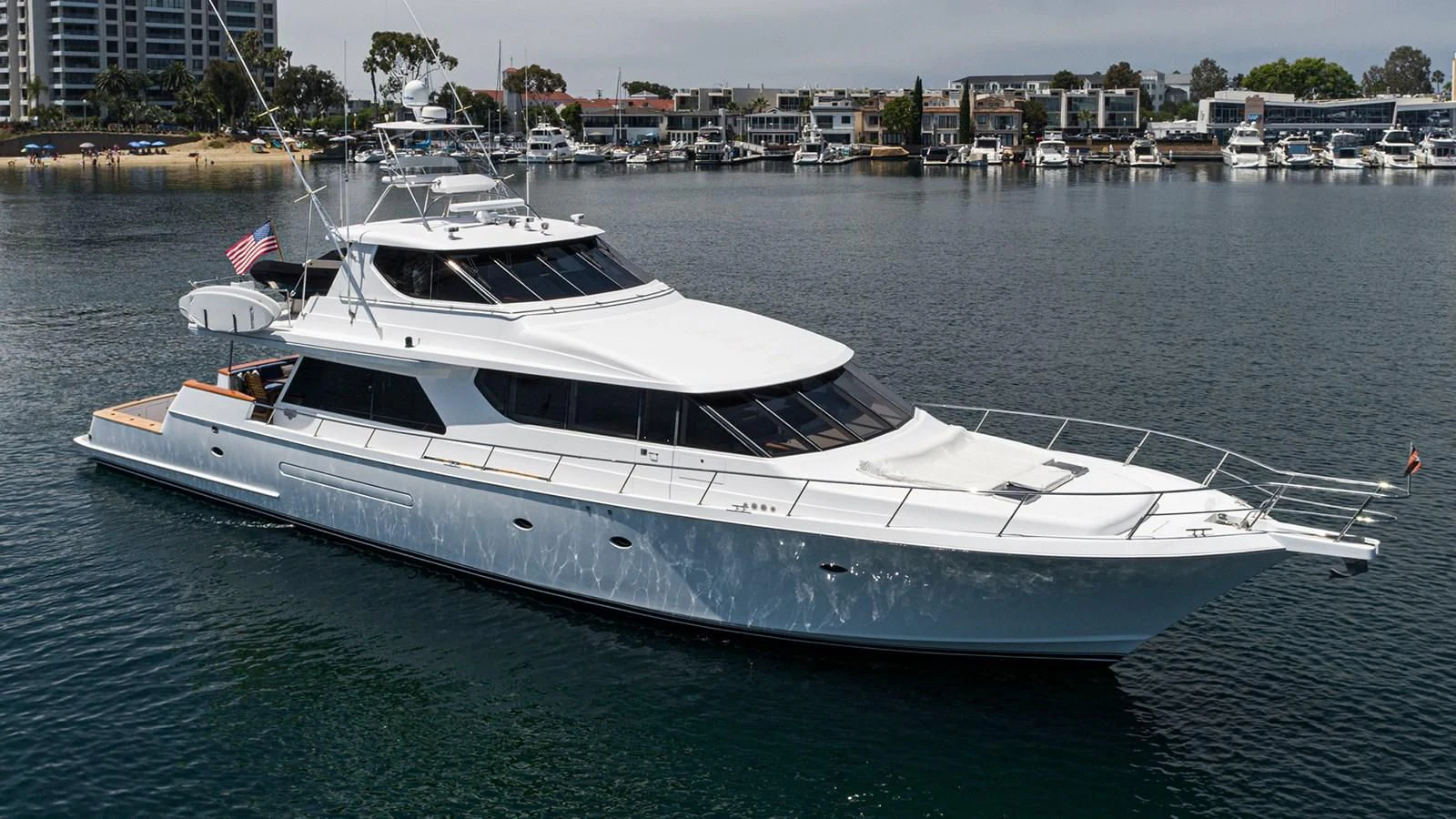 a white yacht in a harbor aboard FAN TAIL Yacht for Sale