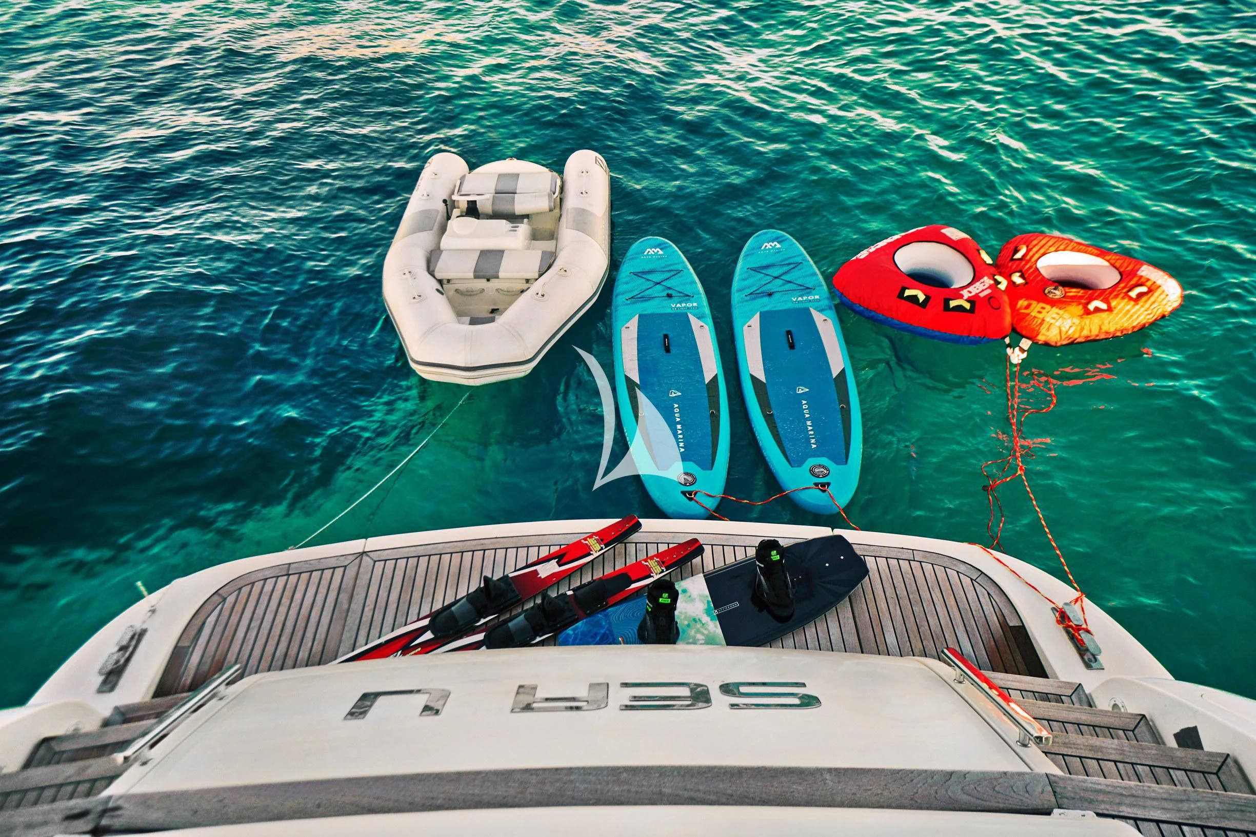a boat with a number of kayaks on it aboard SEA U Yacht for Charter