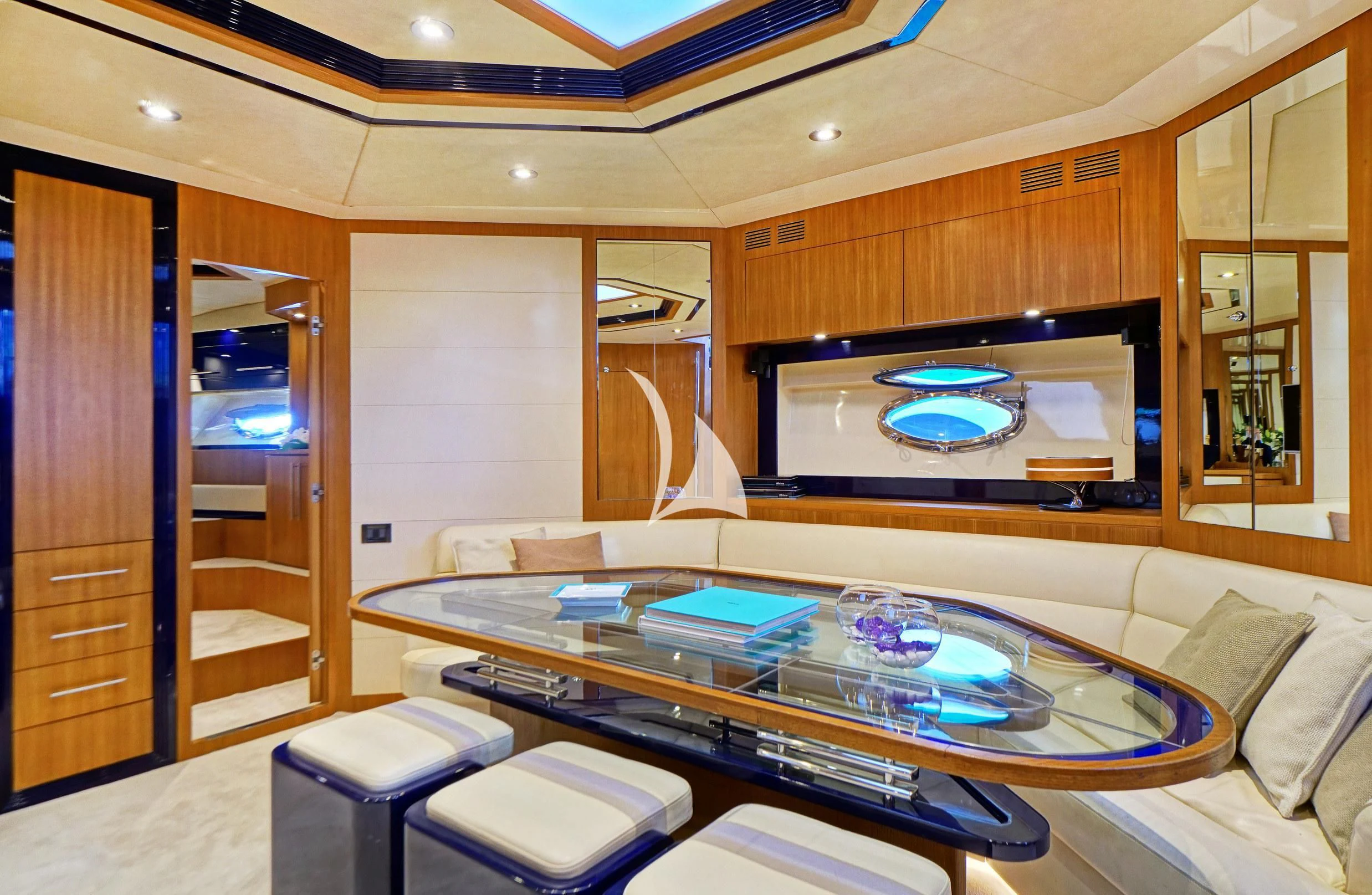 a room with a table and a tv aboard SEA U Yacht for Charter