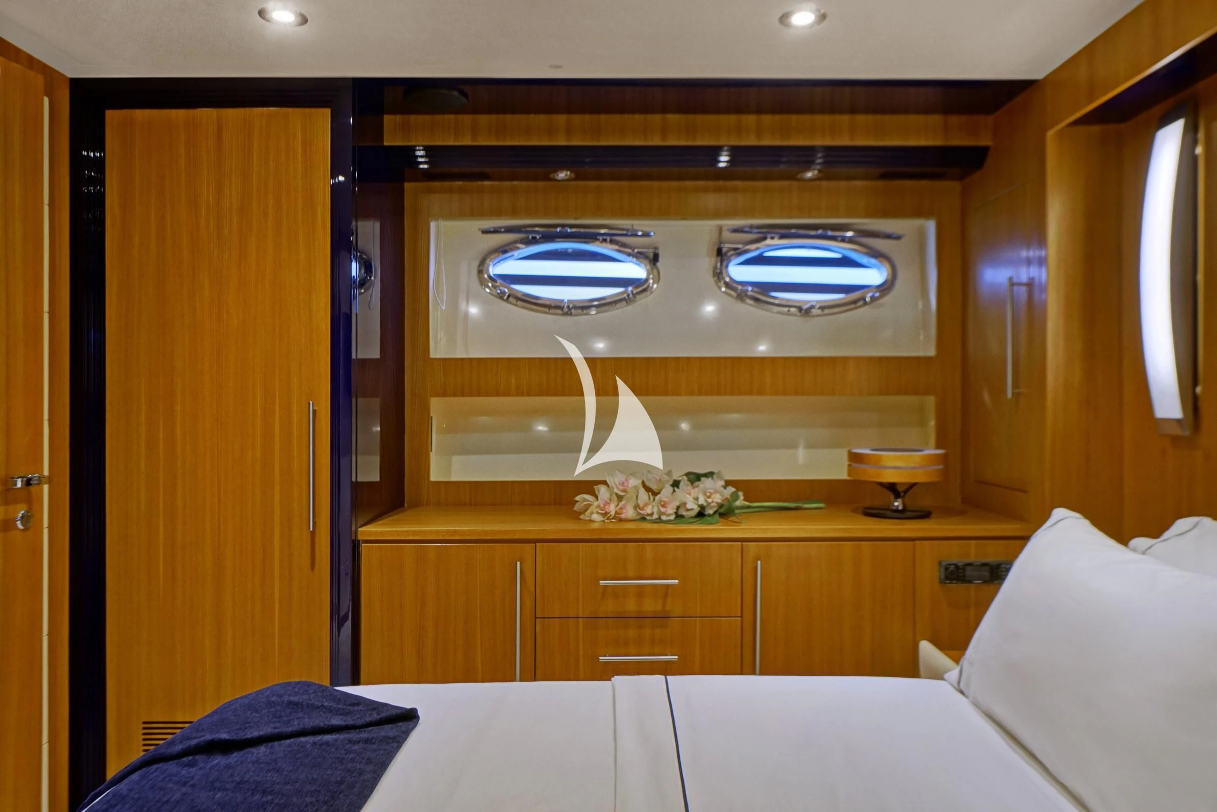 a room with a mirror and a bed aboard SEA U Yacht for Charter