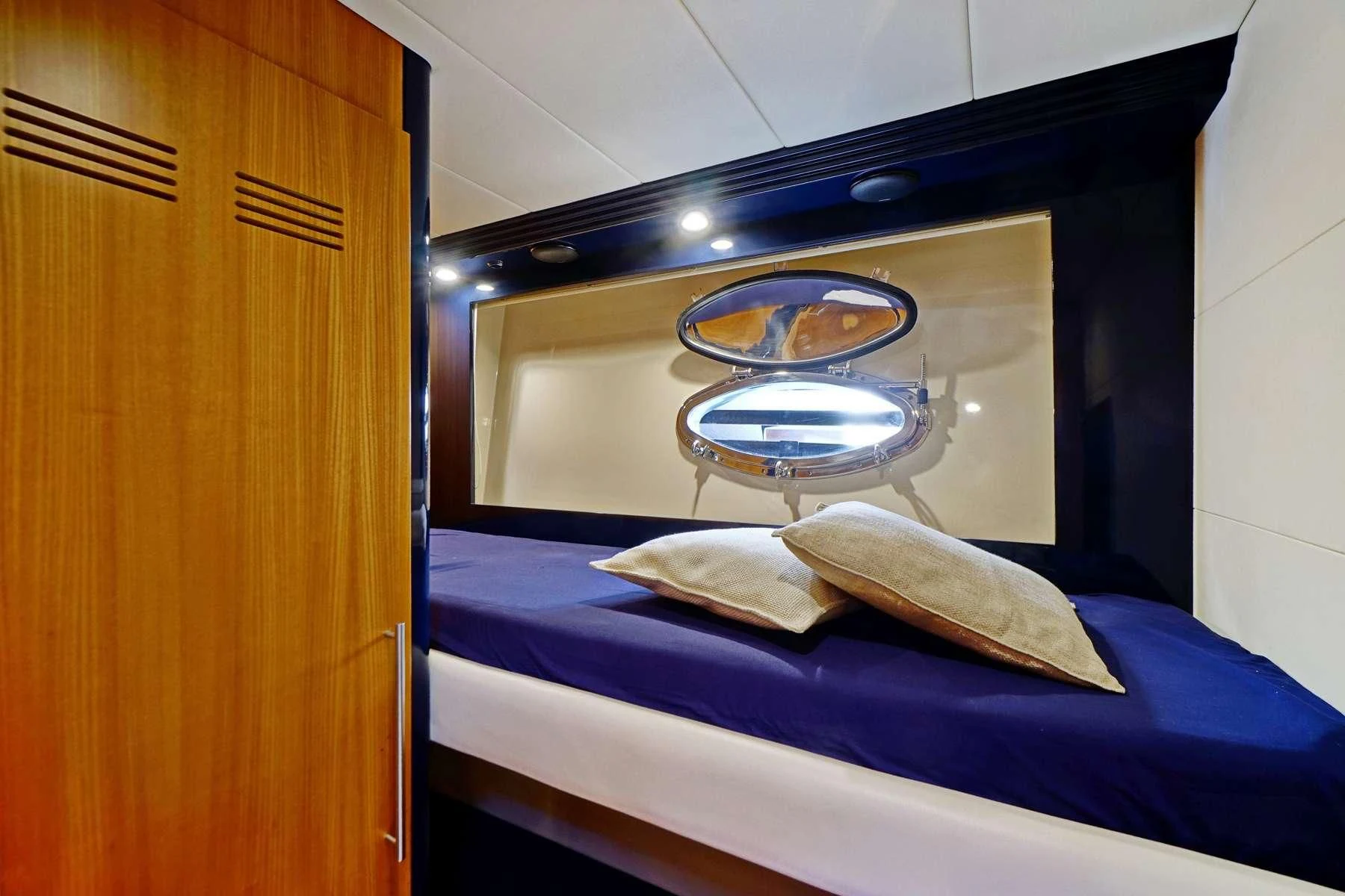 a mirror above a bed aboard SEA U Yacht for Charter