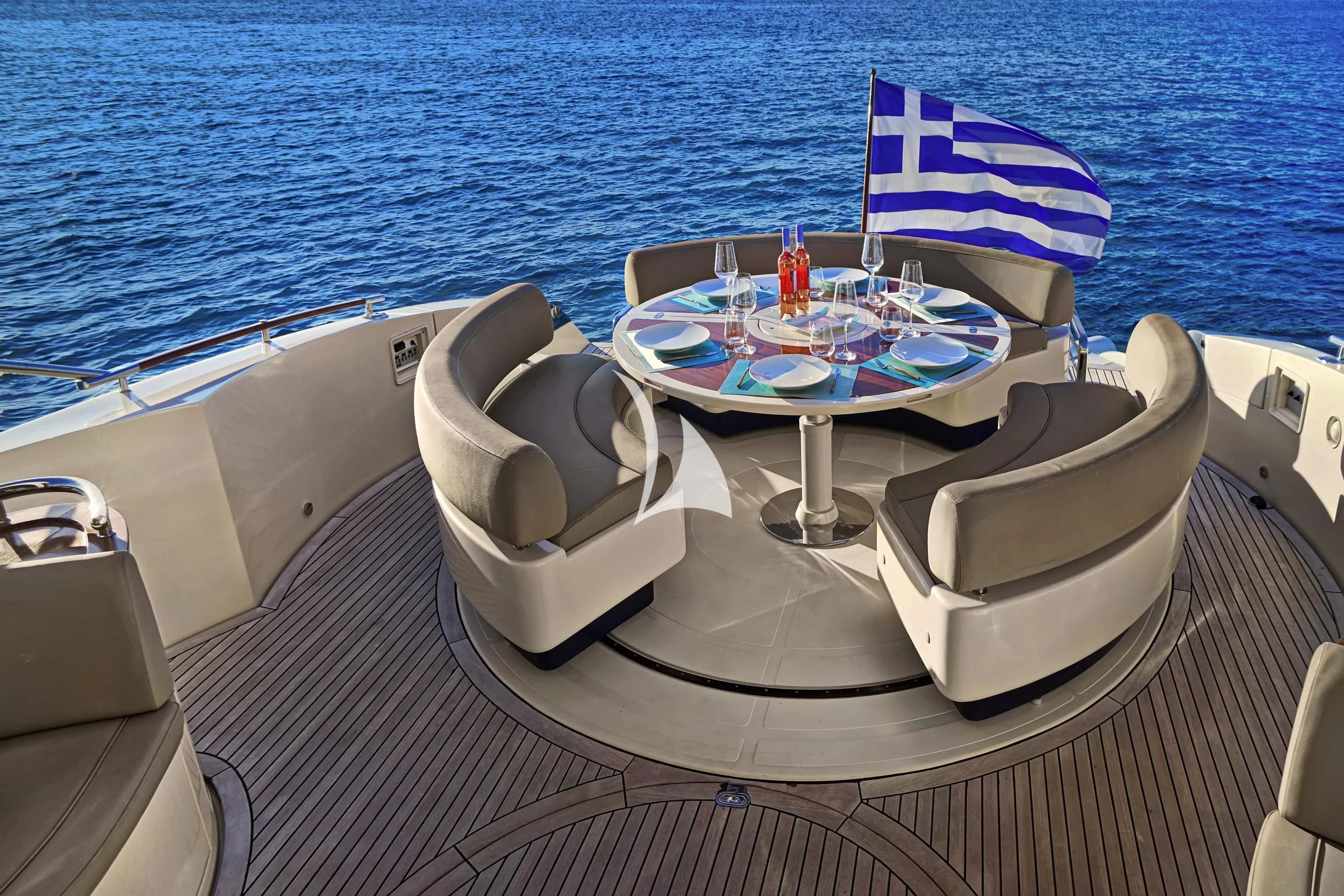 a boat with a flag on the deck aboard SEA U Yacht for Charter