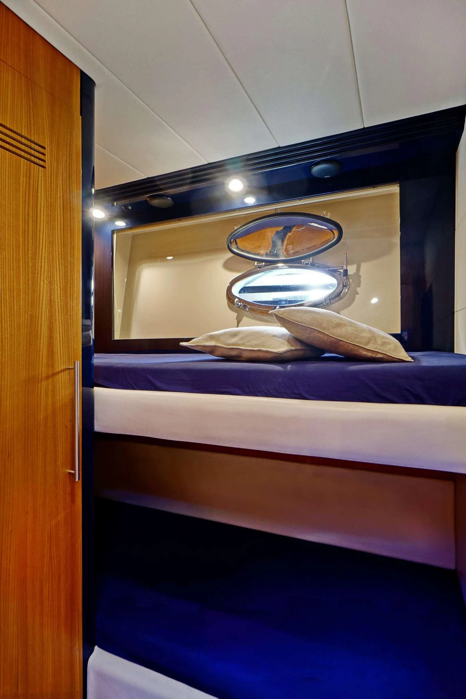 a mirror above a bed aboard SEA U Yacht for Charter