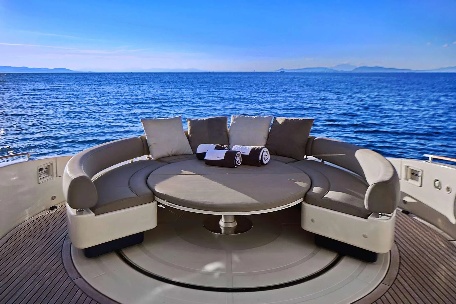 a lounge chair on a deck overlooking a large body of water aboard SEA U Yacht for Charter