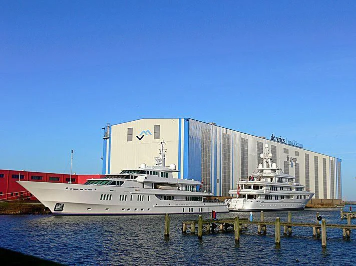 a large cruise ship docked at a port aboard SIRAN Yacht for Sale