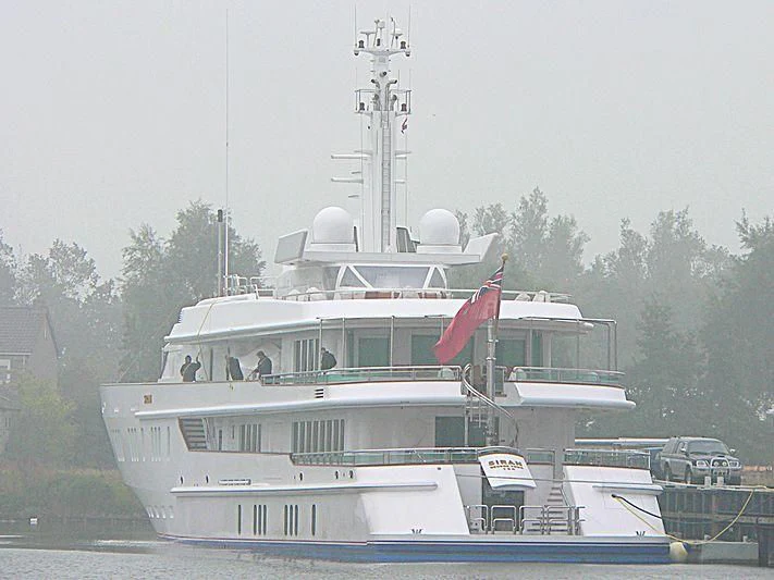a large white boat with a flag on it aboard SIRAN Yacht for Sale