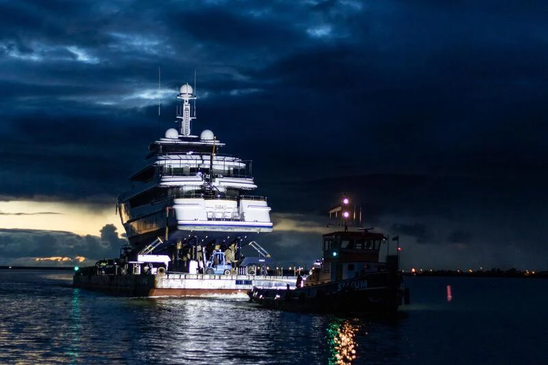 a large ship in the water with Maiden's Tower in the background aboard SIRAN Yacht for Sale