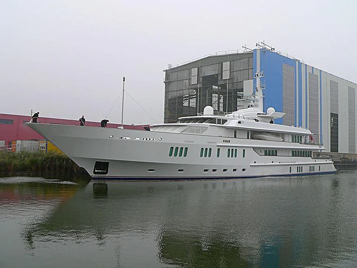 a large white boat in a harbor aboard SIRAN Yacht for Sale
