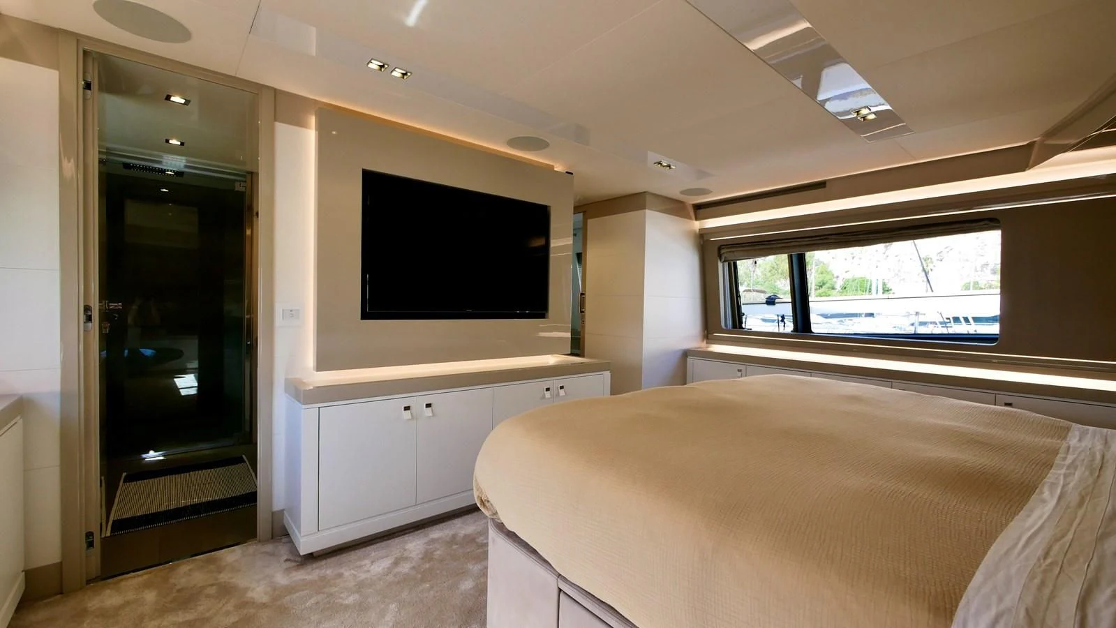 a bedroom with a bed and a television aboard MIOTU 4 Yacht for Sale