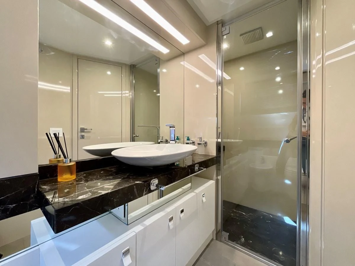 a bathroom with a glass shower aboard MIOTU 4 Yacht for Sale