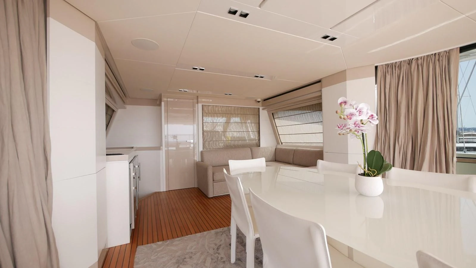 a white dining room with a table and chairs aboard MIOTU 4 Yacht for Sale