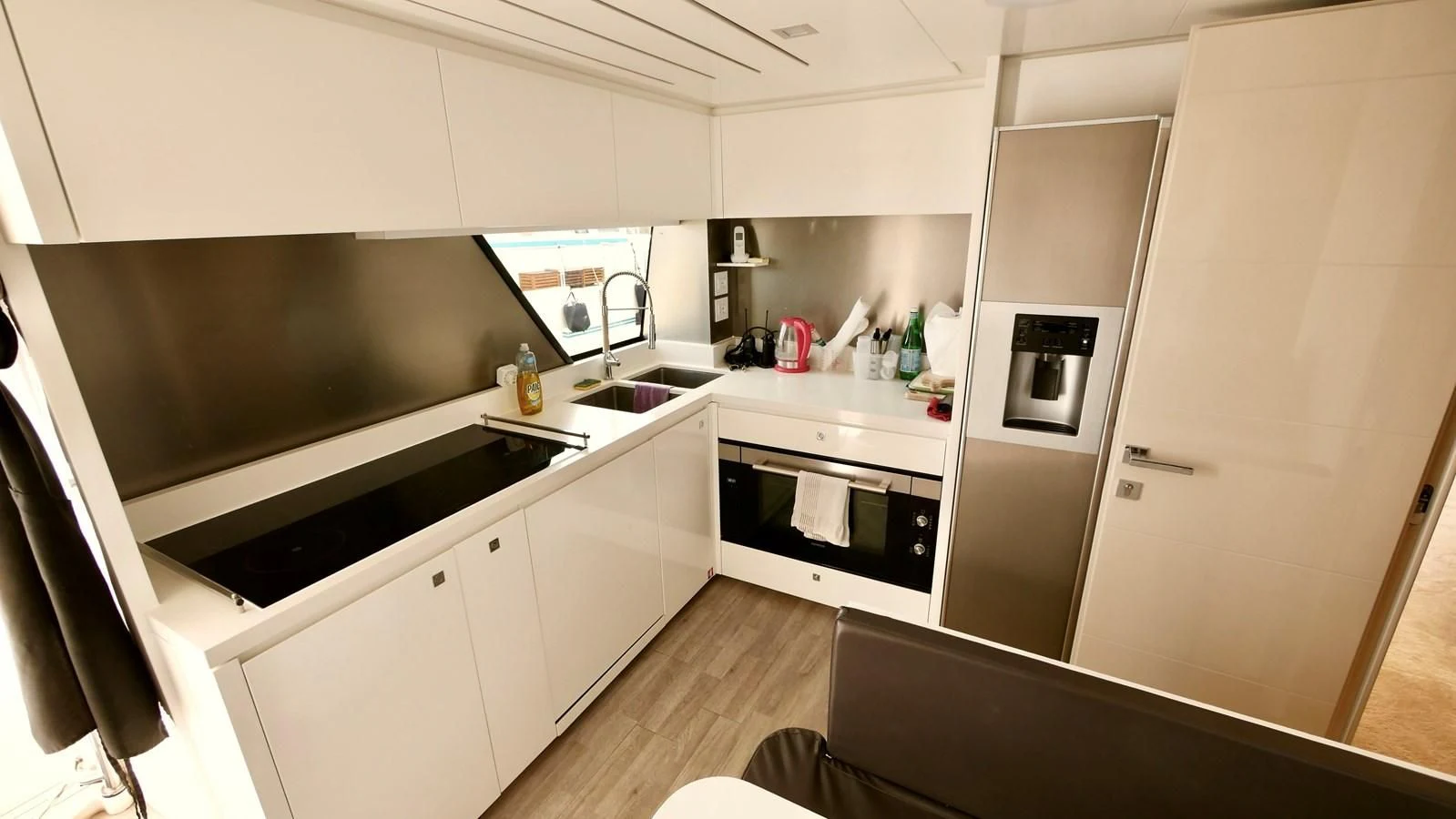 a kitchen with white cabinets aboard MIOTU 4 Yacht for Sale